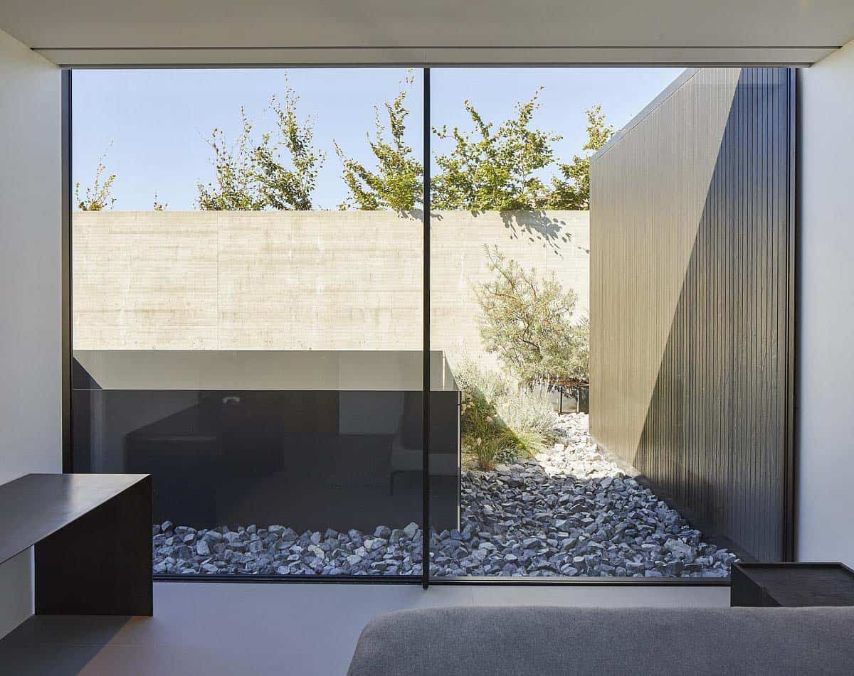 modern bedroom with a wall of glass and view to an outdoor courtyard