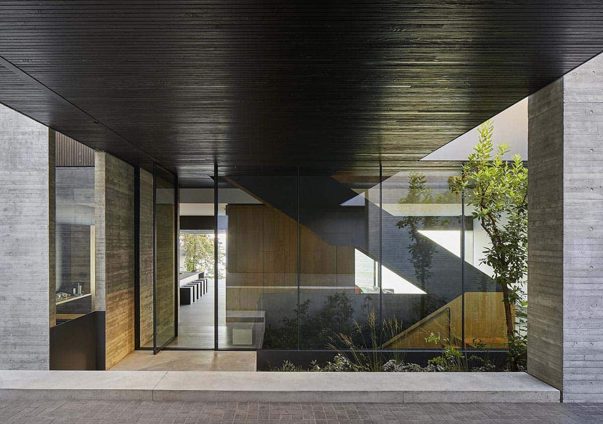 modern home exterior with a glass view of the interior staircase