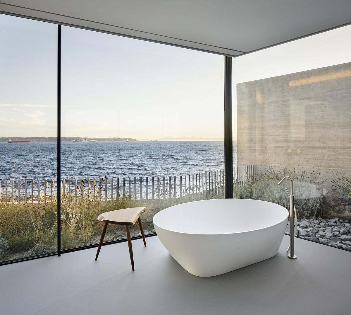 modern bathroom with a wall of glass and view to the ocean