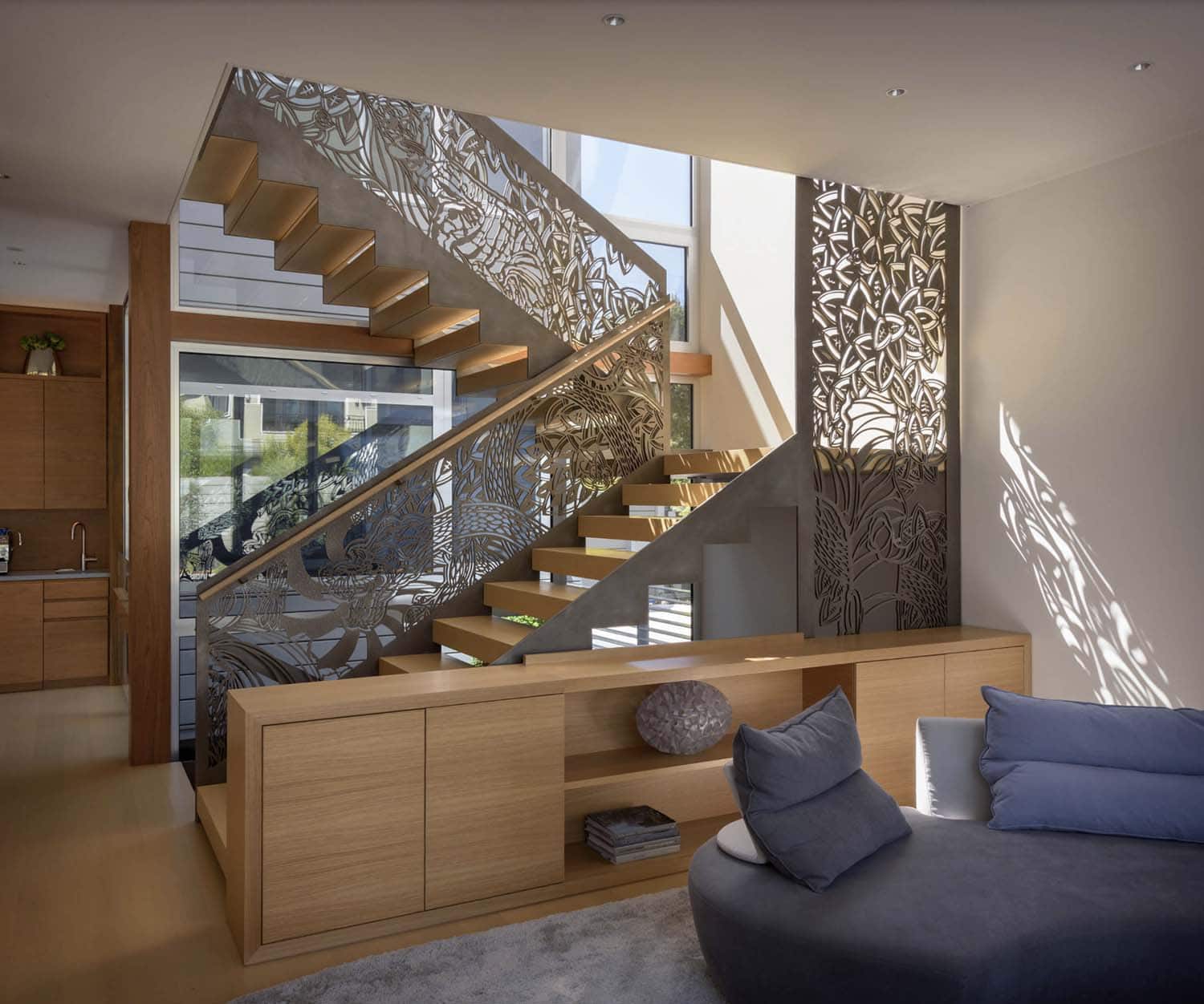modern living room with a built-in divider wall and staircase