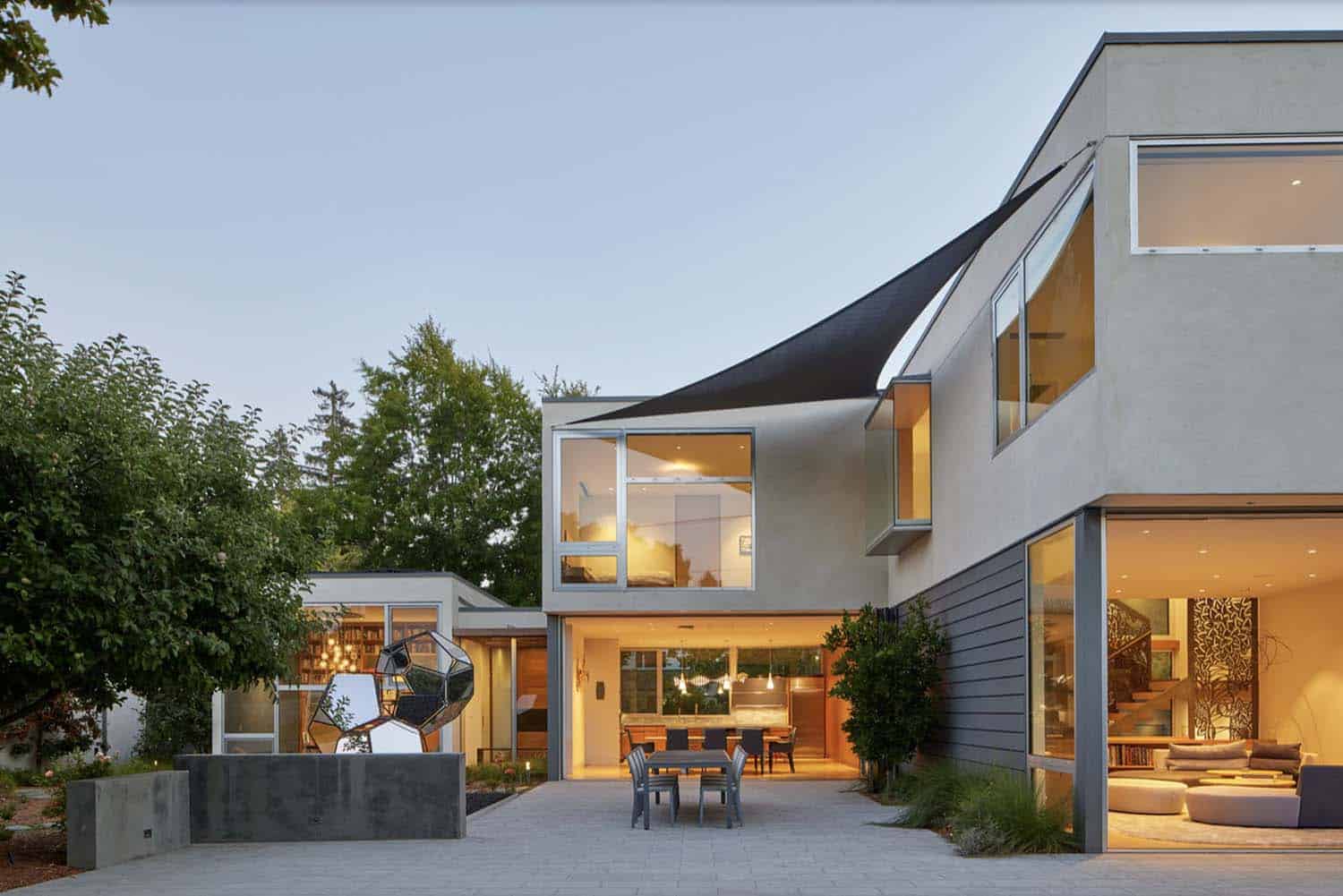 modern home exterior with a patio at dusk