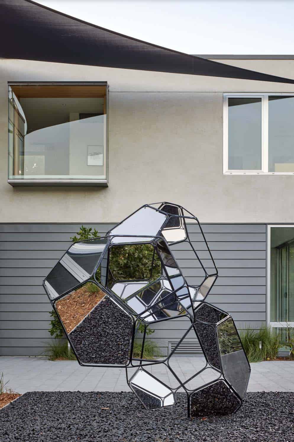 modern home exterior with an outdoor sculpture