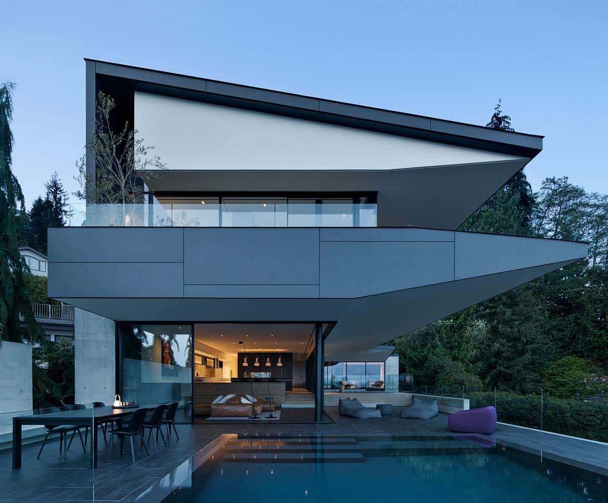 modern house exterior with a pool view at dusk