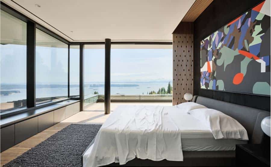 modern bedroom with walls of glass and an ocean view