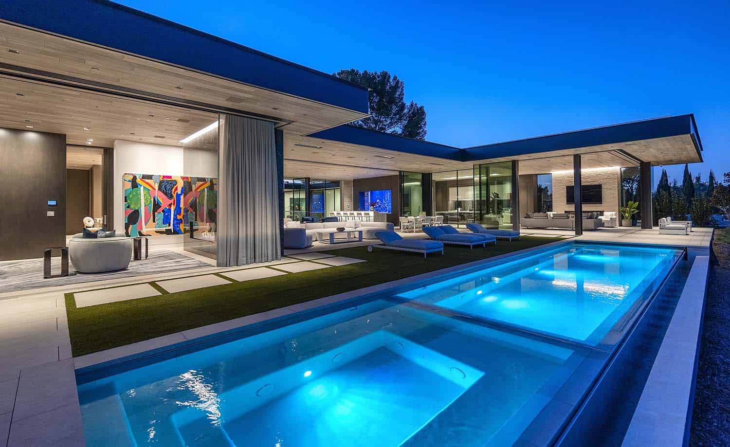 modern home exterior with a pool and spa
