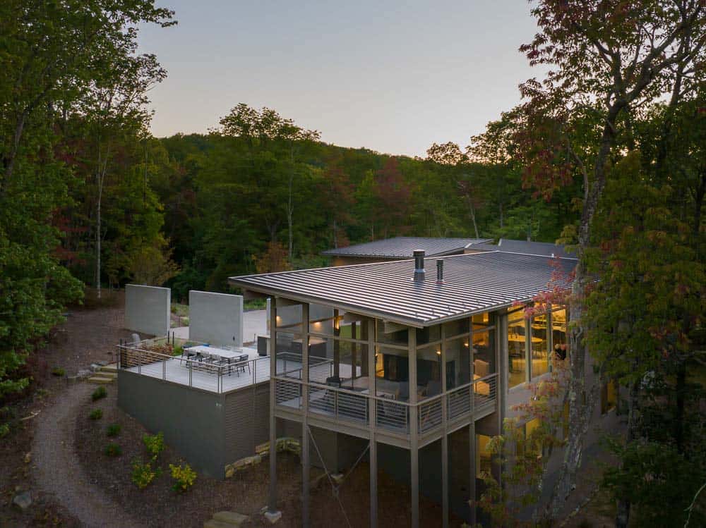 modern mountainside home exterior at dusk