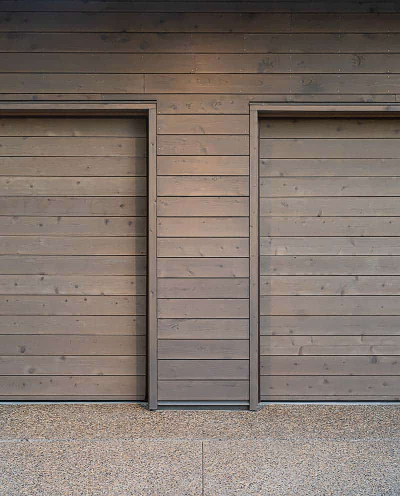 modern mountainside home exterior garage doors