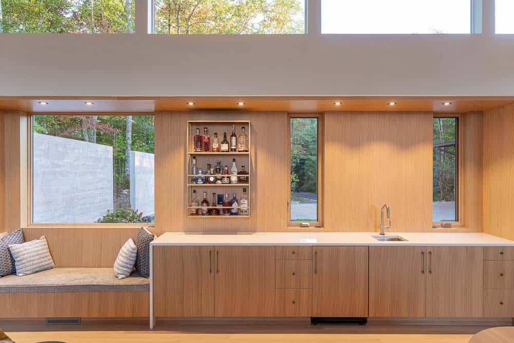 modern home bar with a built-in window seat