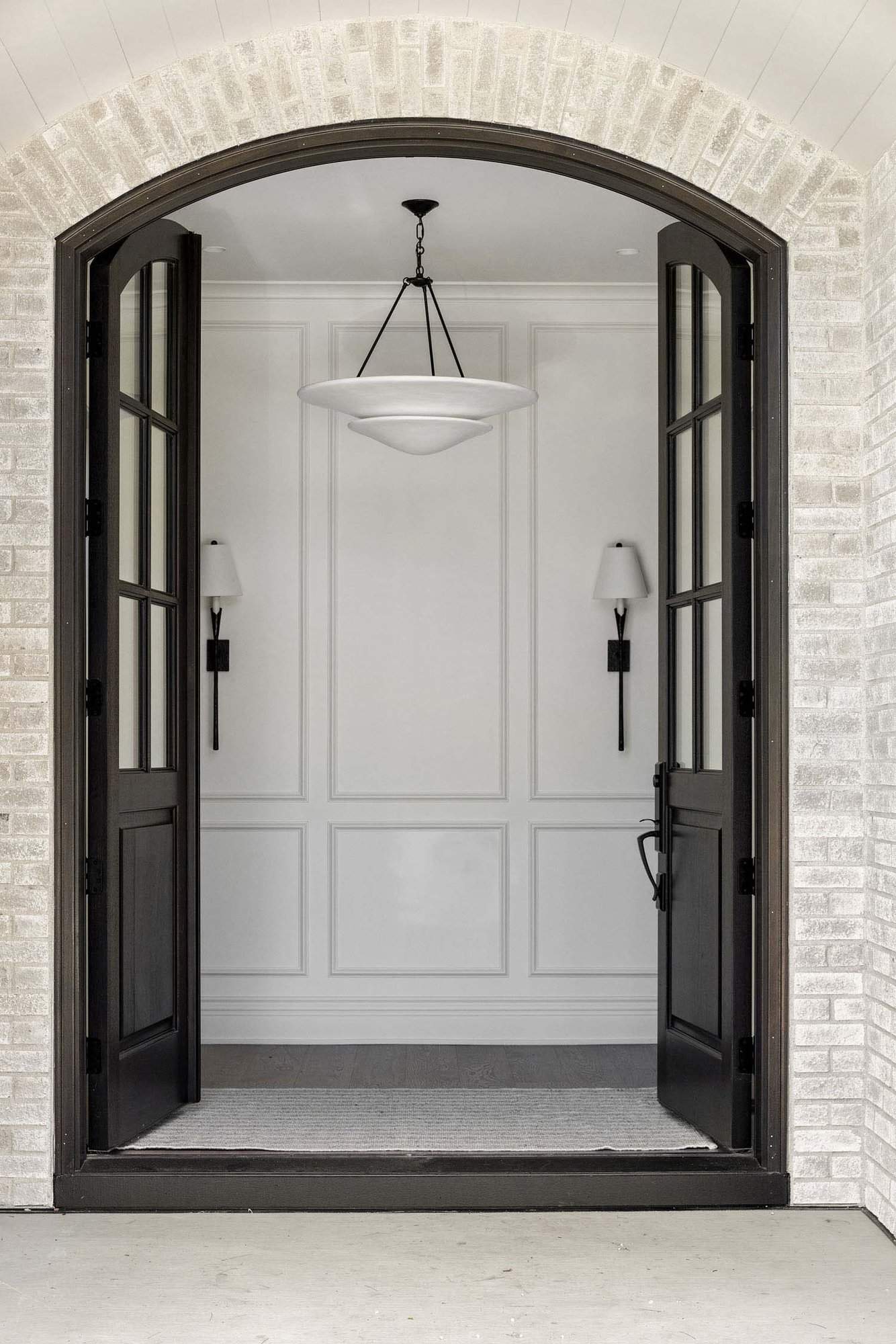 modern traditional home entry with a chandelier