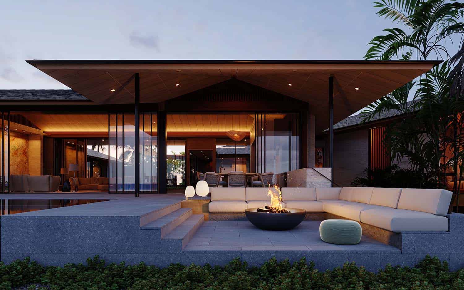 modern tropical house exterior with a patio and fire pit