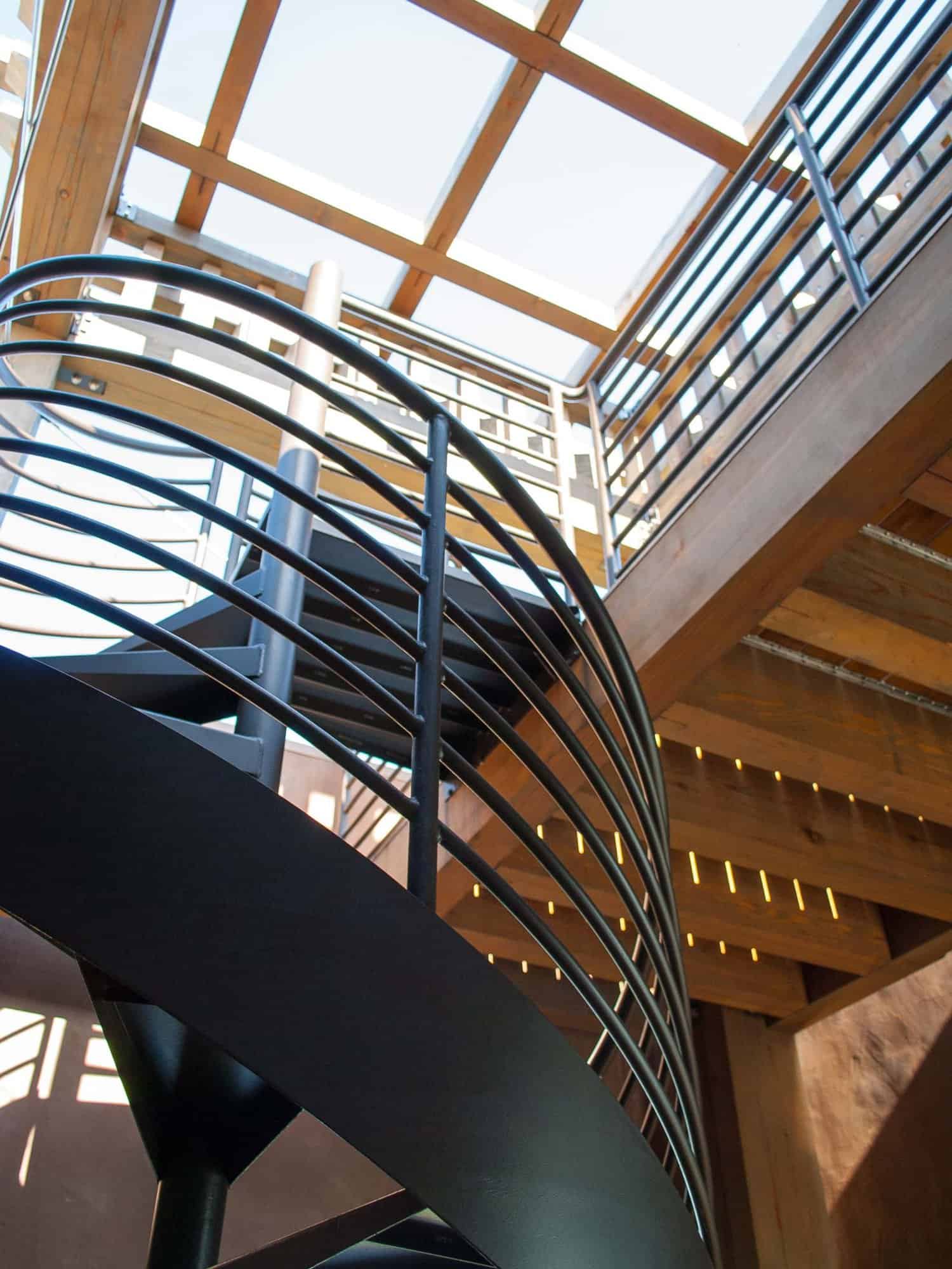 modern spiral staircase with a skylight