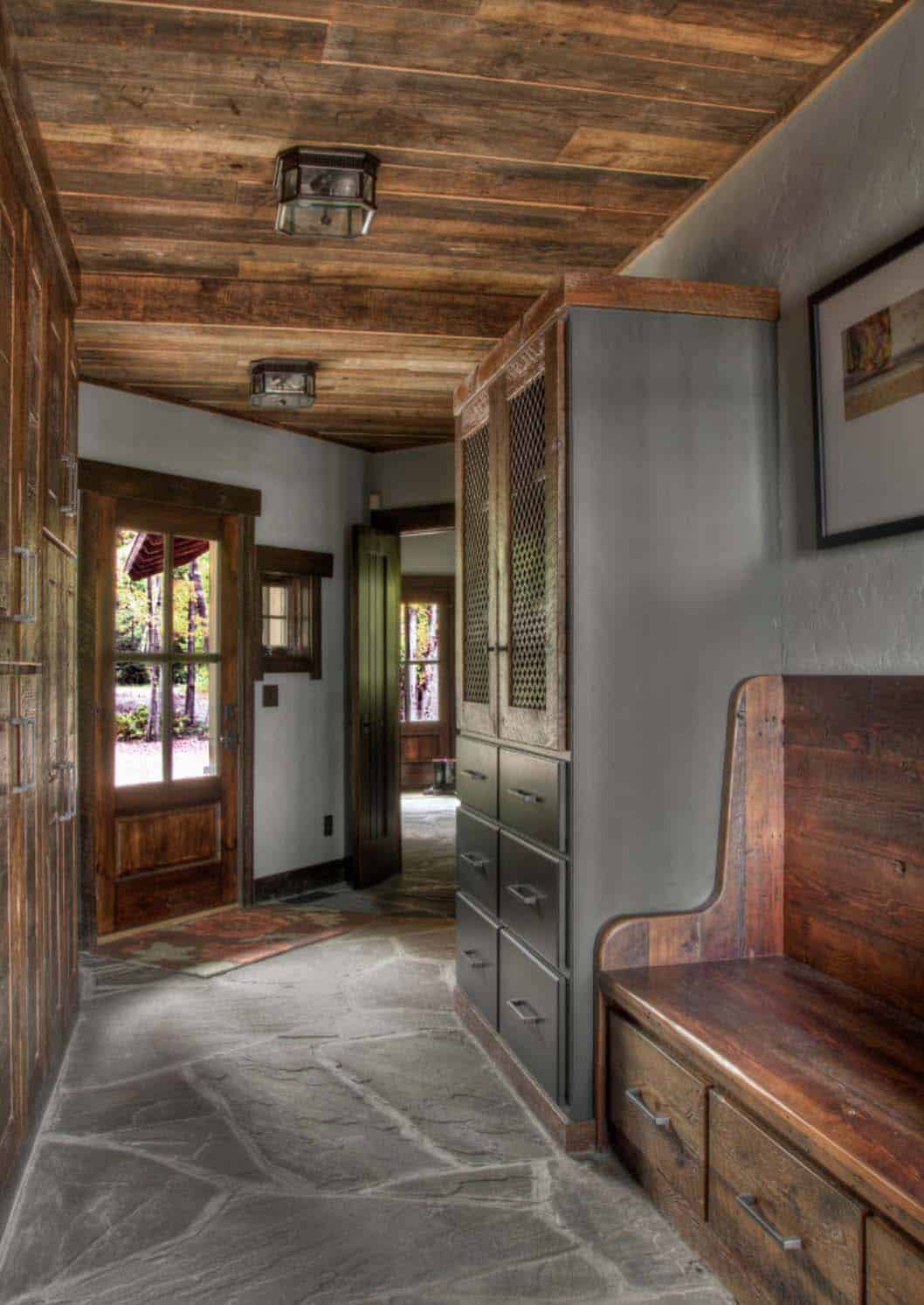 rustic mudroom entry with a bench