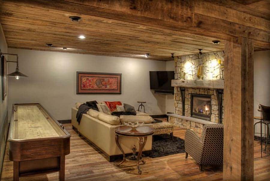 rustic lower level family room with a fireplace and a shuffle board