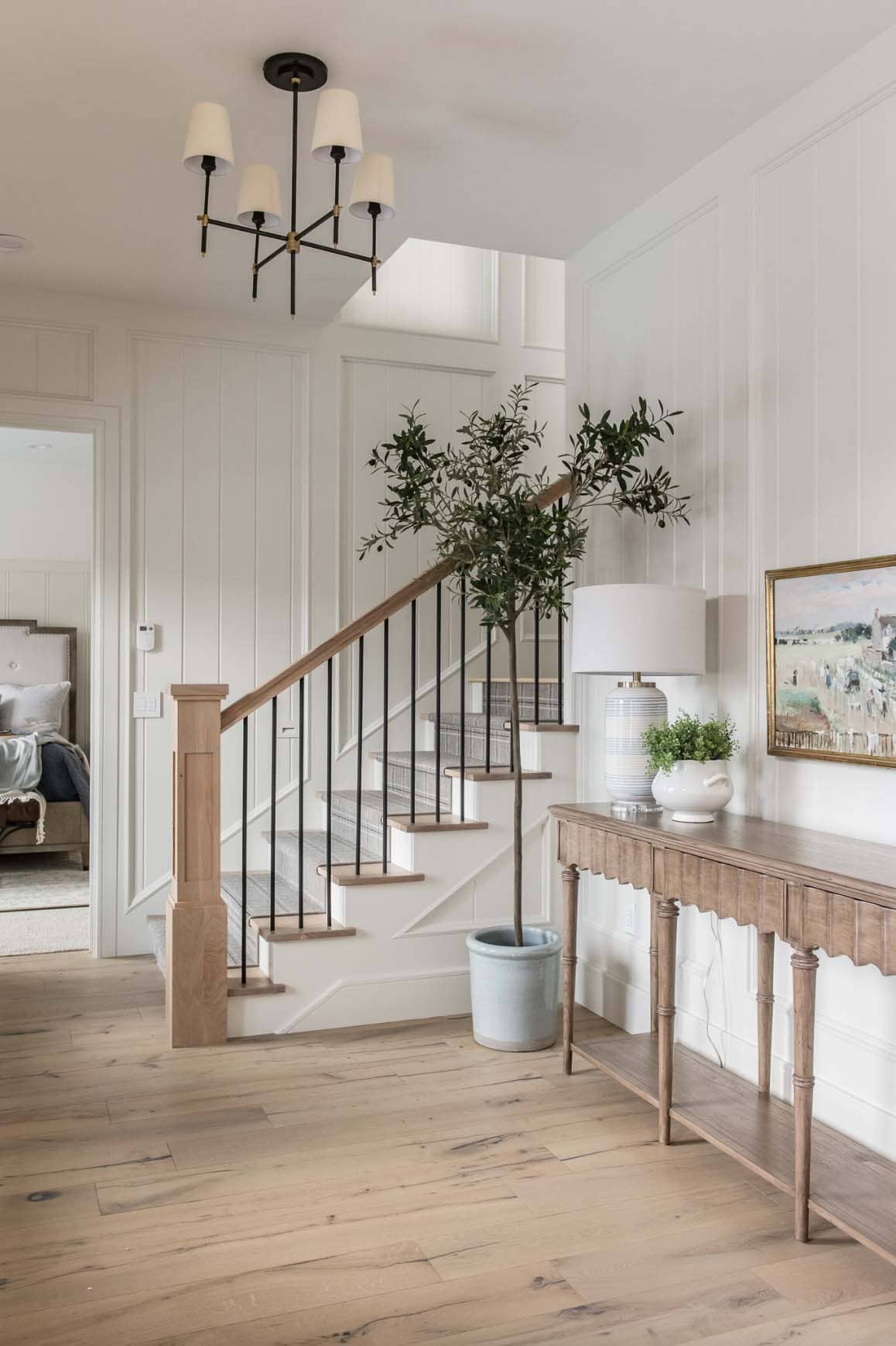 traditional farmhouse style entry with a console table and staircase
