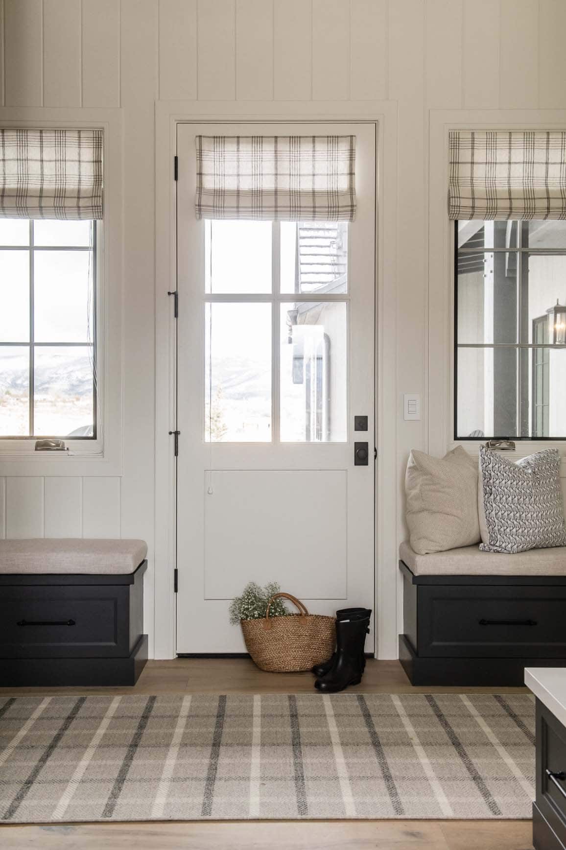traditional farmhouse style home entry with benches flanking the door