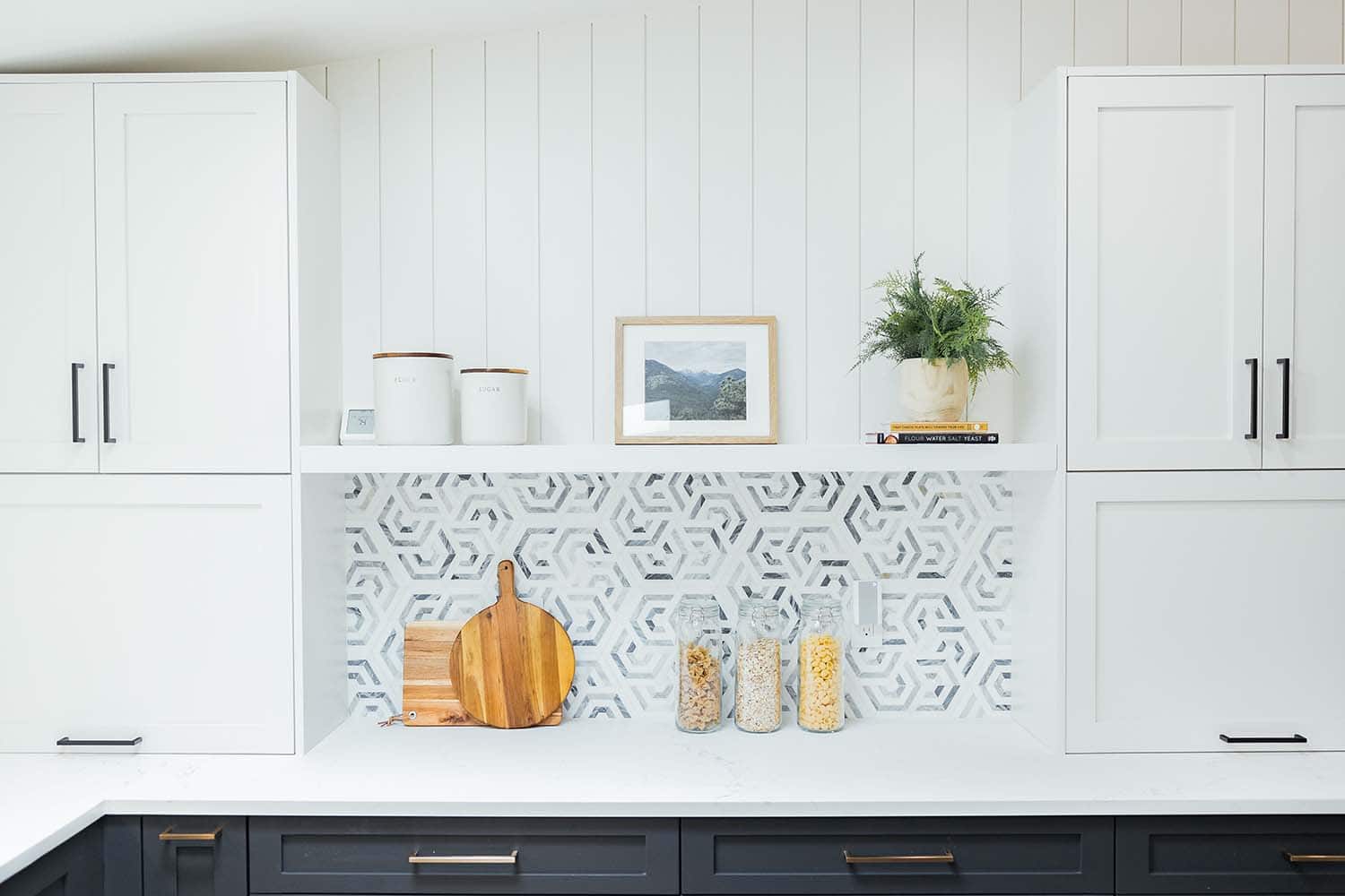 modern kitchen with open shelves and a pattern backsplash tile