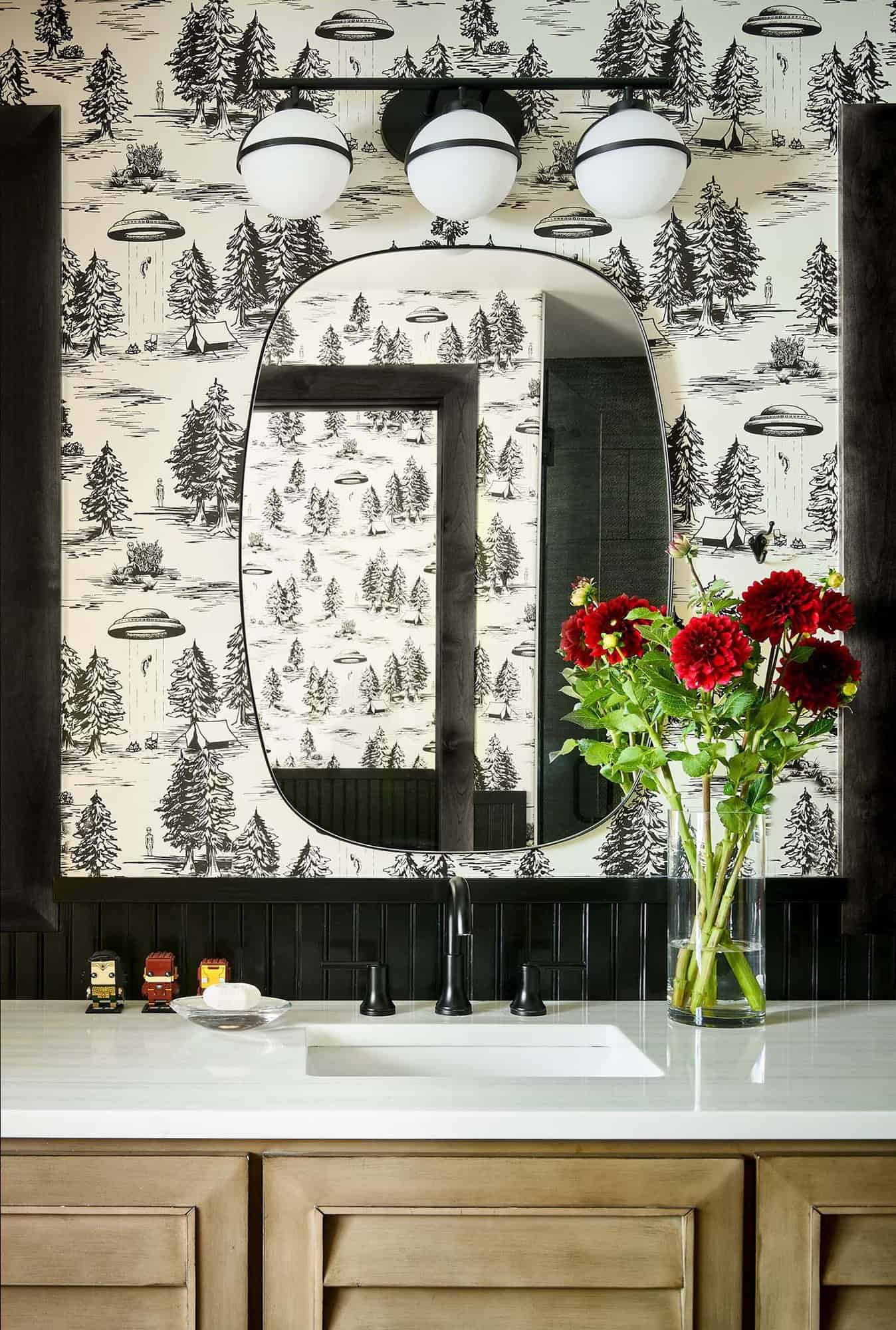 black and white powder bath with whimsical UFO wallpaper