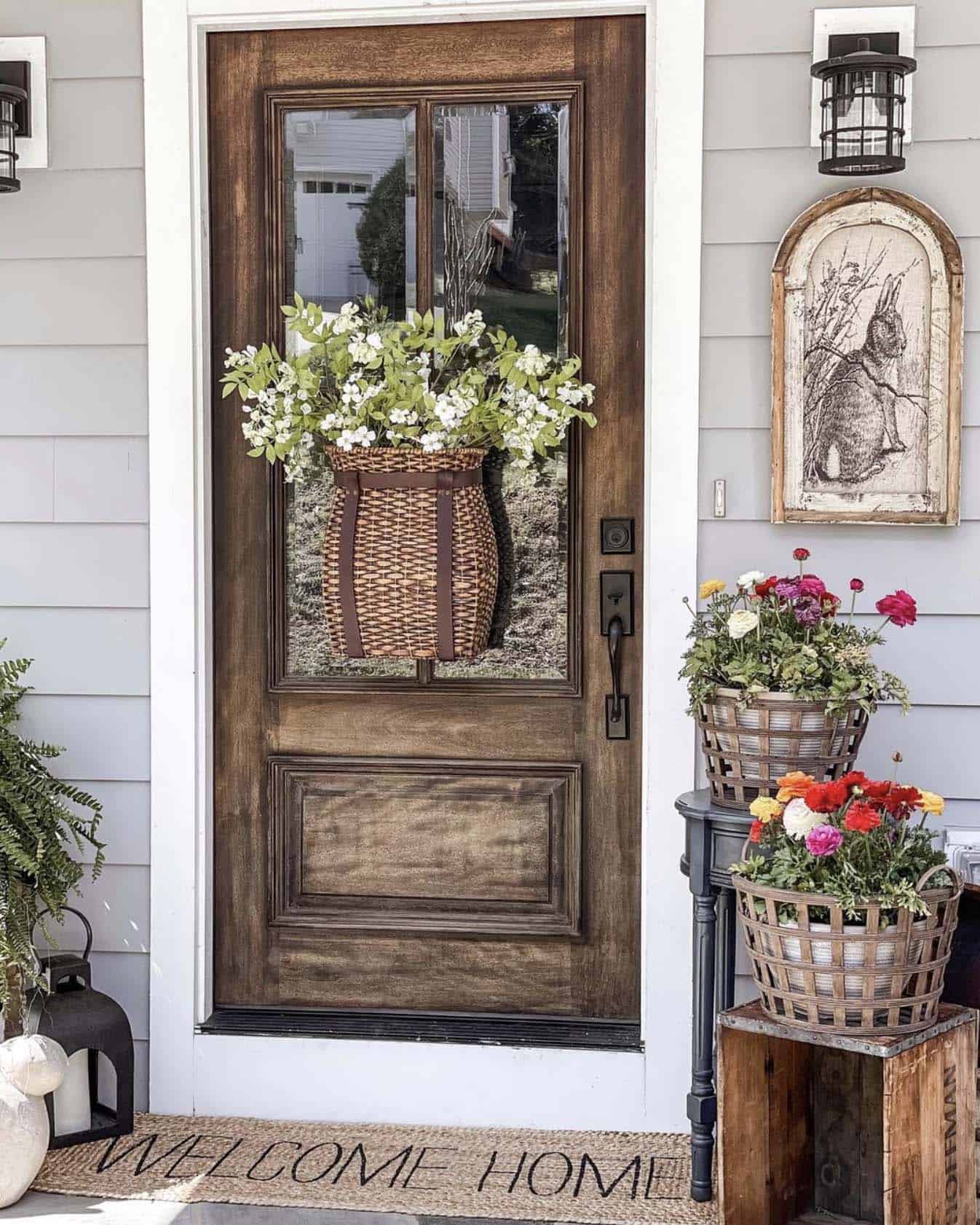 spring decor on the front porch with a hanging basket on the door and bunny artwork on the wall