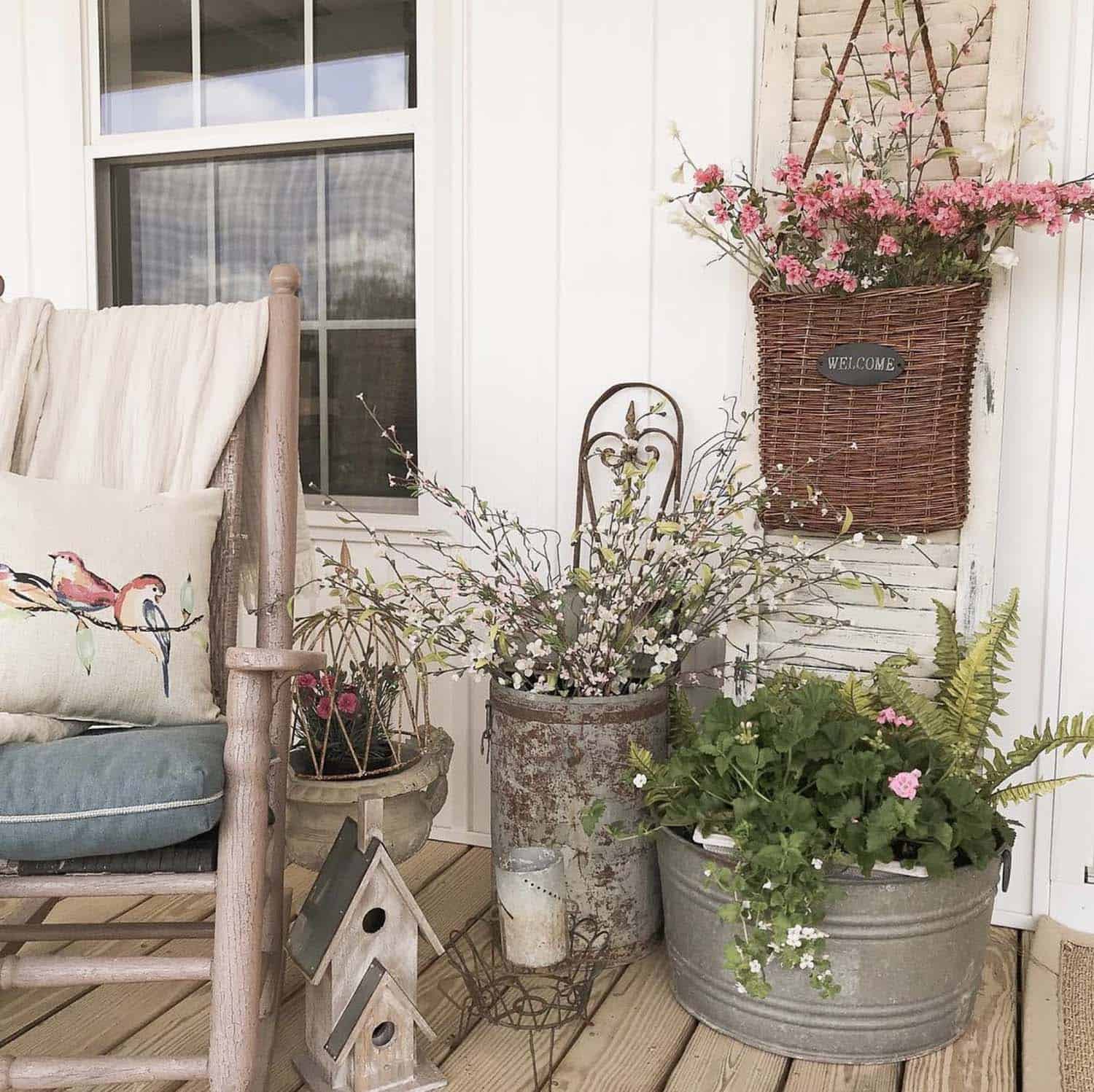 front porch with baskets filled with fresh spring flowers