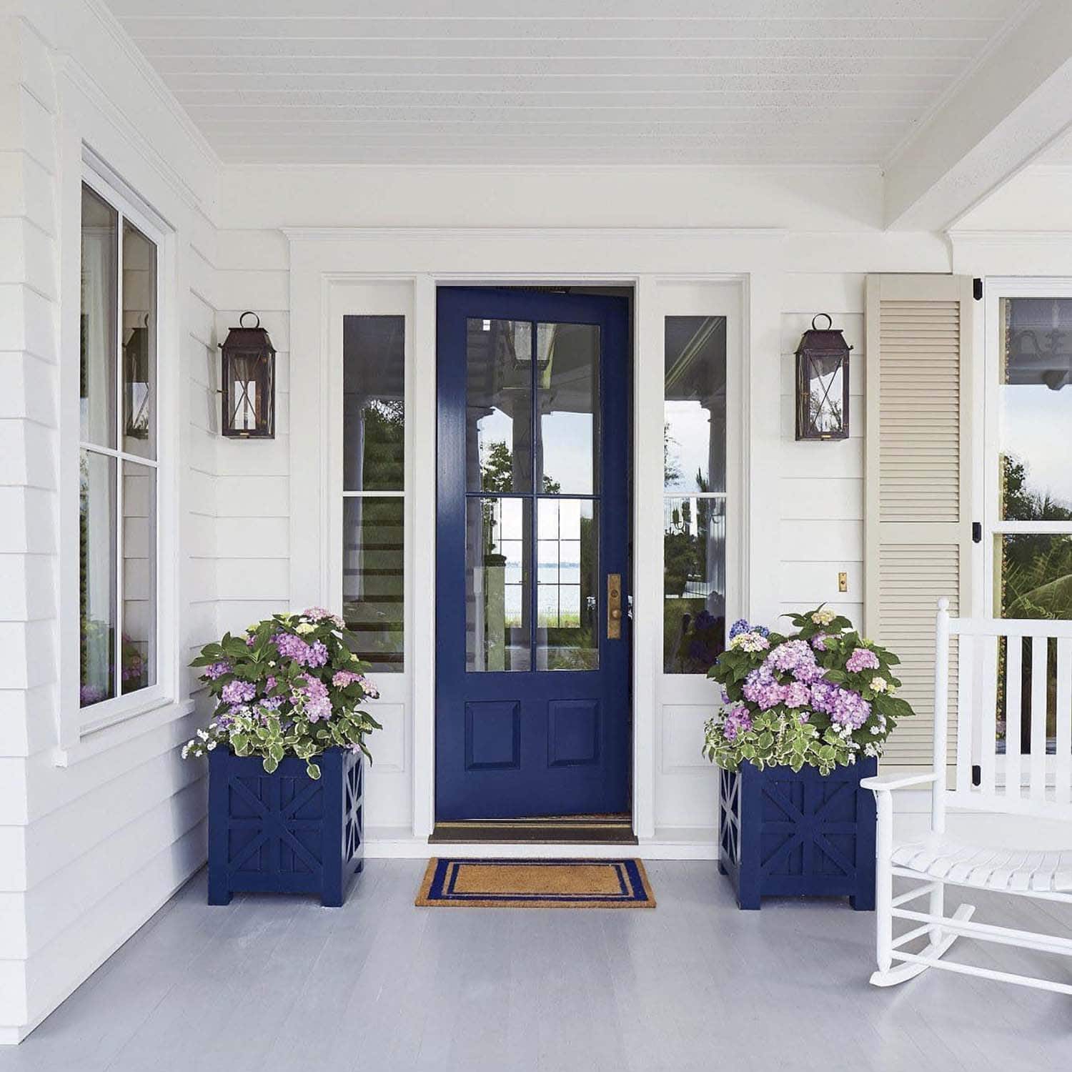crisp navy and white themed spring porch decor with potted flowers