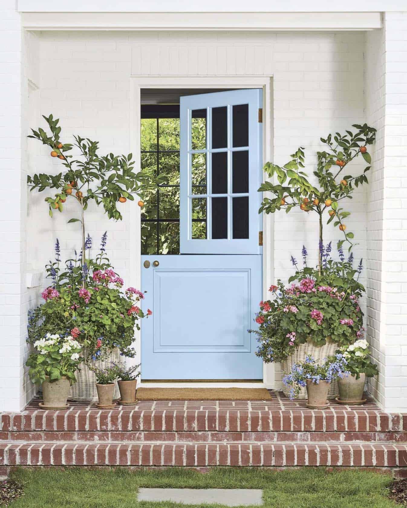 spring front porch with a blue painted dutch door