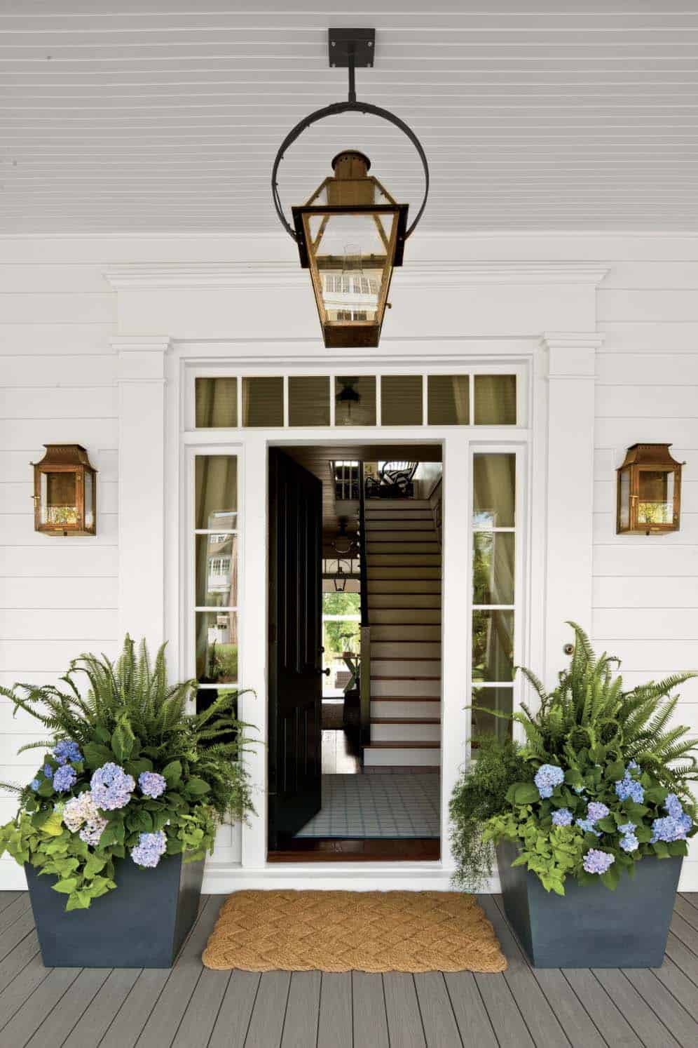 front porch with large planters and fresh spring flowers