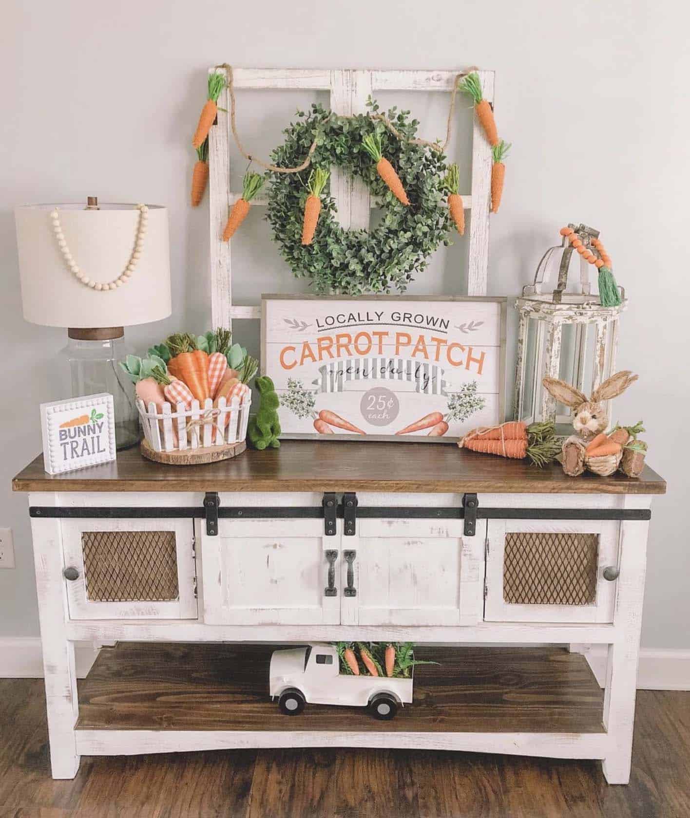 console table decorated for spring with carrot themed decor