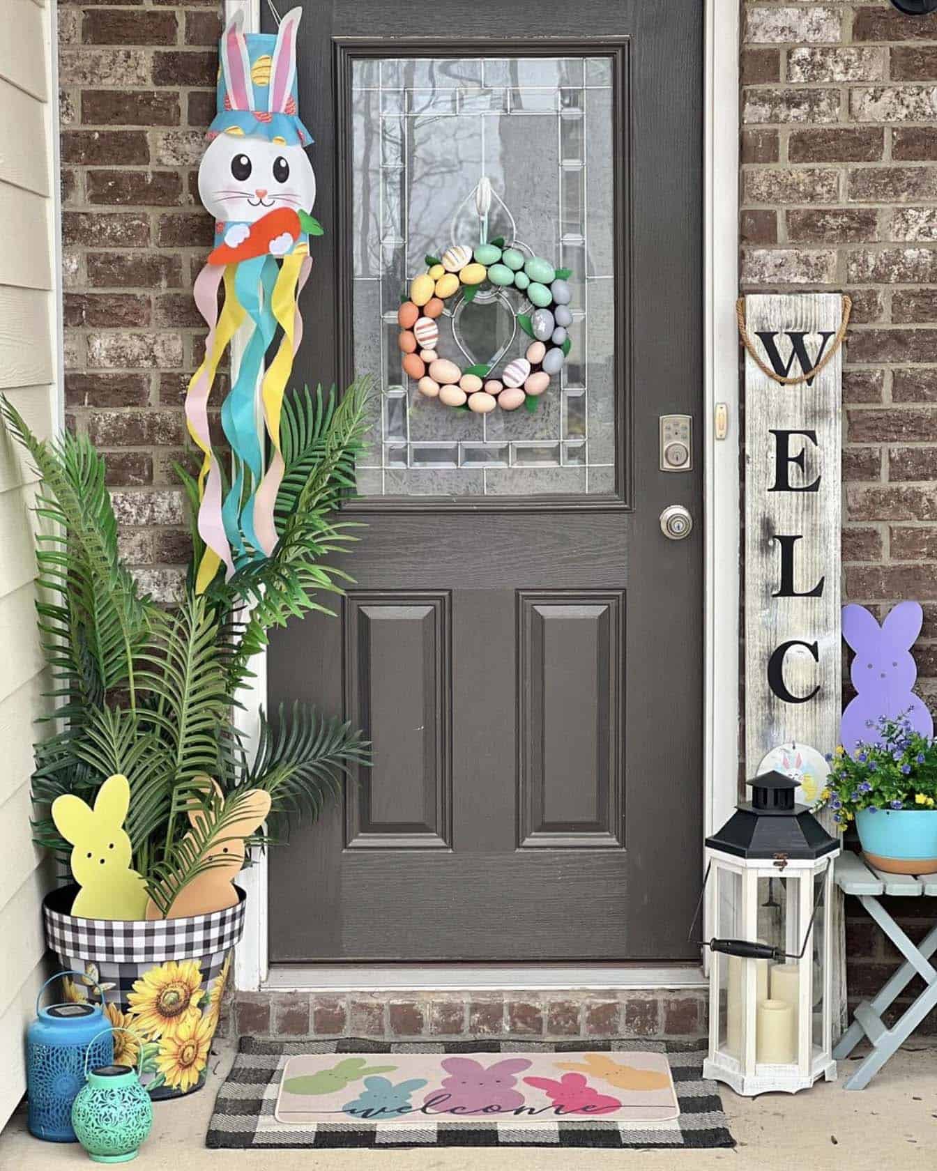 front door decorated with spring decor and an Easter egg wreath