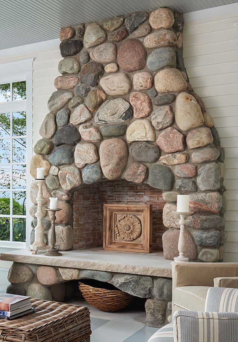 traditional coastal style sunroom with a stone fireplace