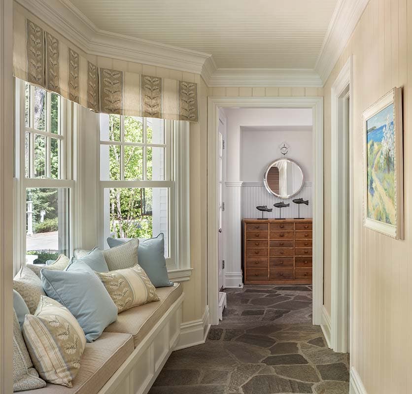 traditional coastal style hallway with a built-in window seat