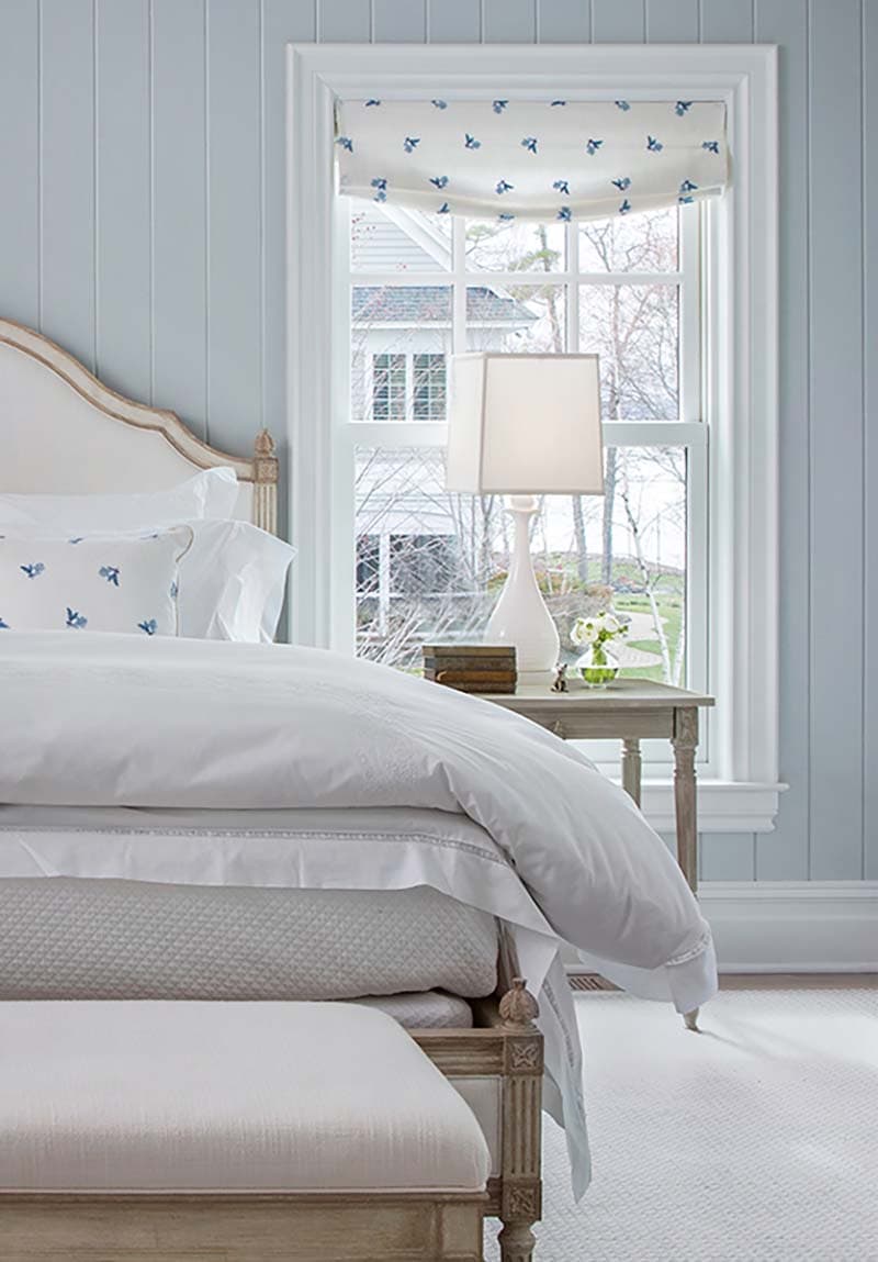 traditional coastal style bedroom with shiplap walls