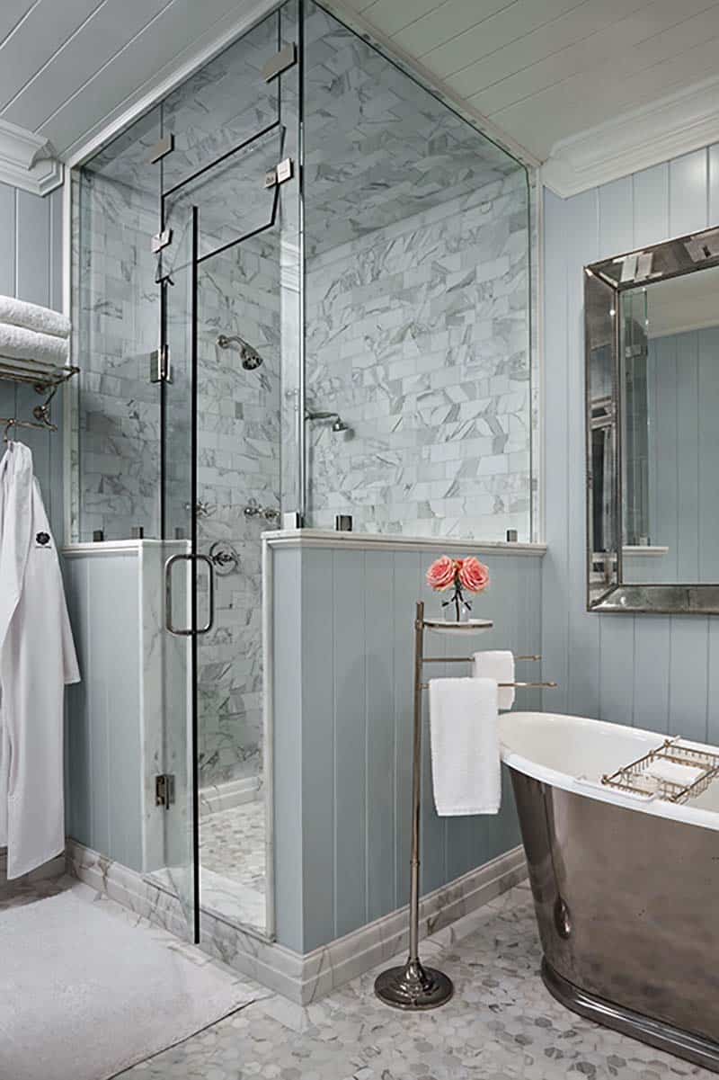 traditional coastal style bathroom with a soaking tub and shower