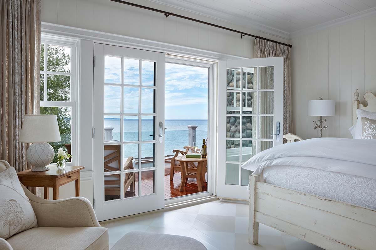 traditional coastal style bedroom with French doors leading out to a private terrace