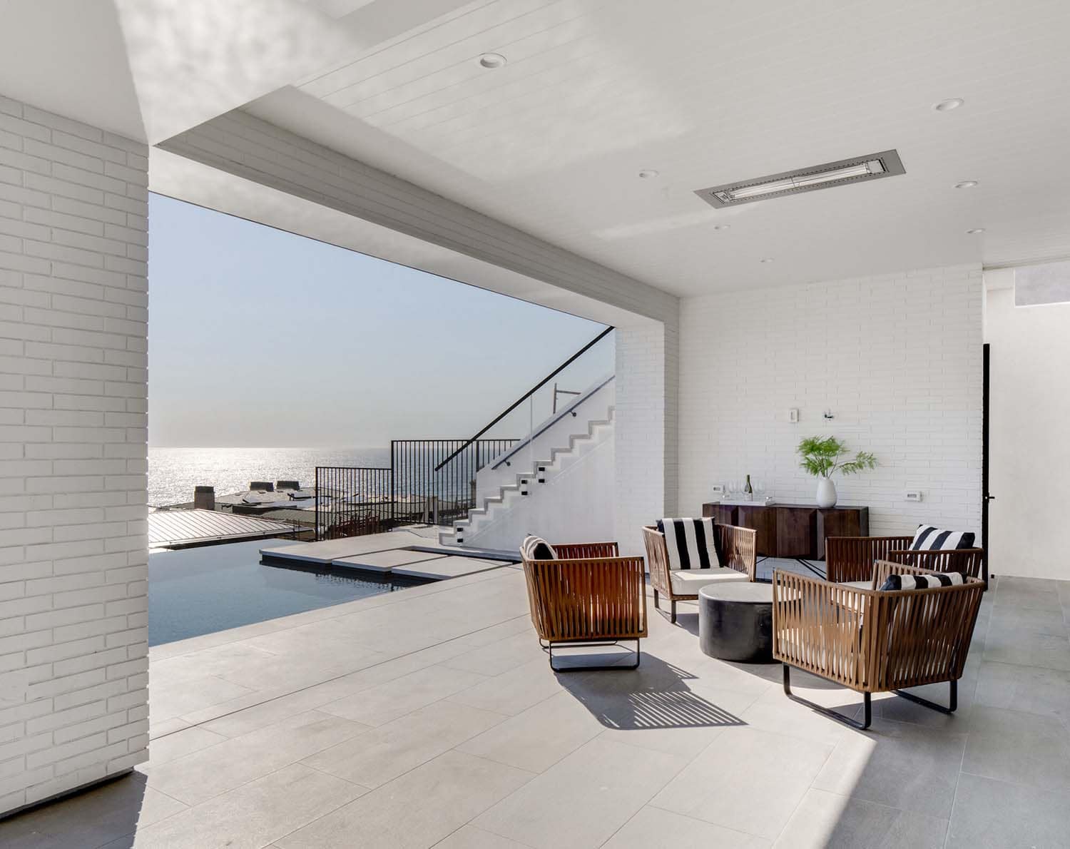coastal contemporary family room open to the swimming pool