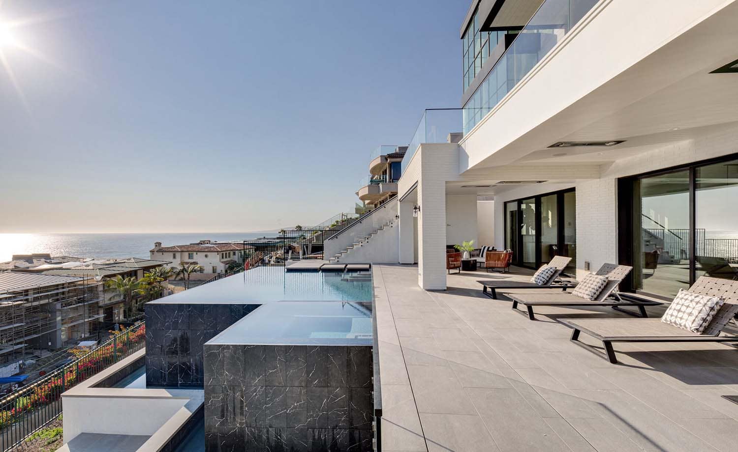 coastal contemporary covered patio with a swimming pool