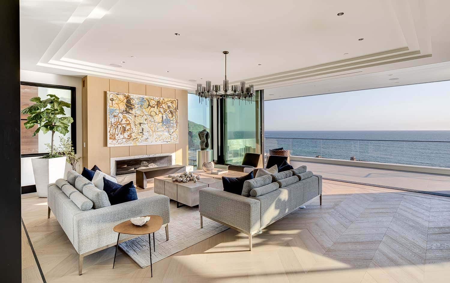 coastal contemporary living room with a sliding glass door that opens to the ocean