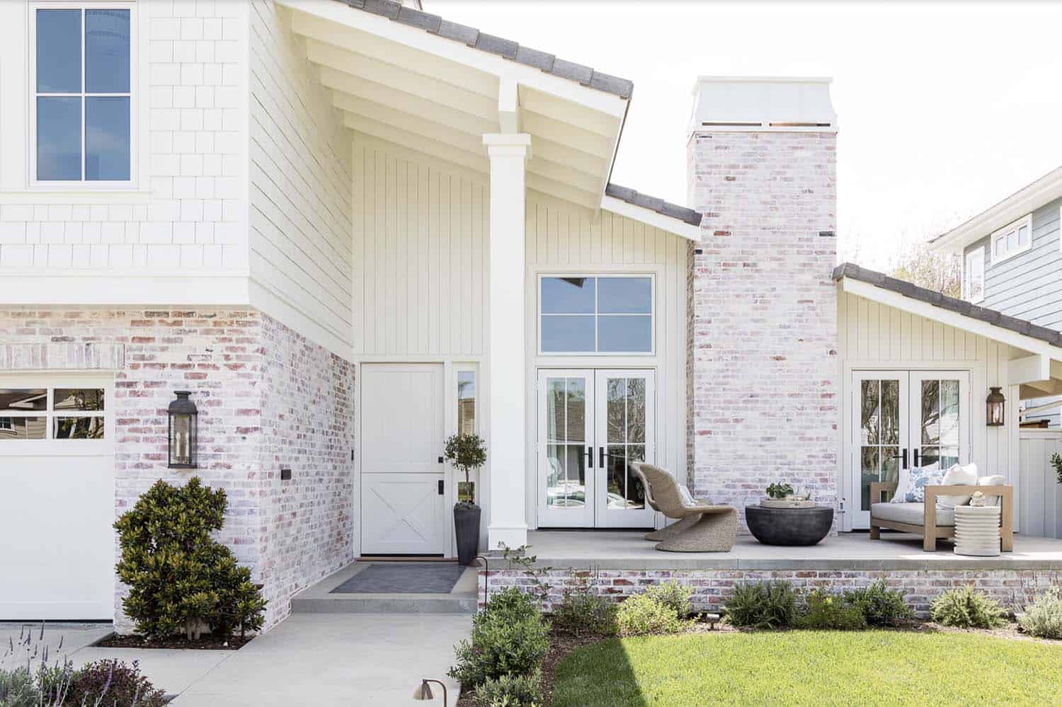 coastal home exterior with a Dutch door and white-washed brick