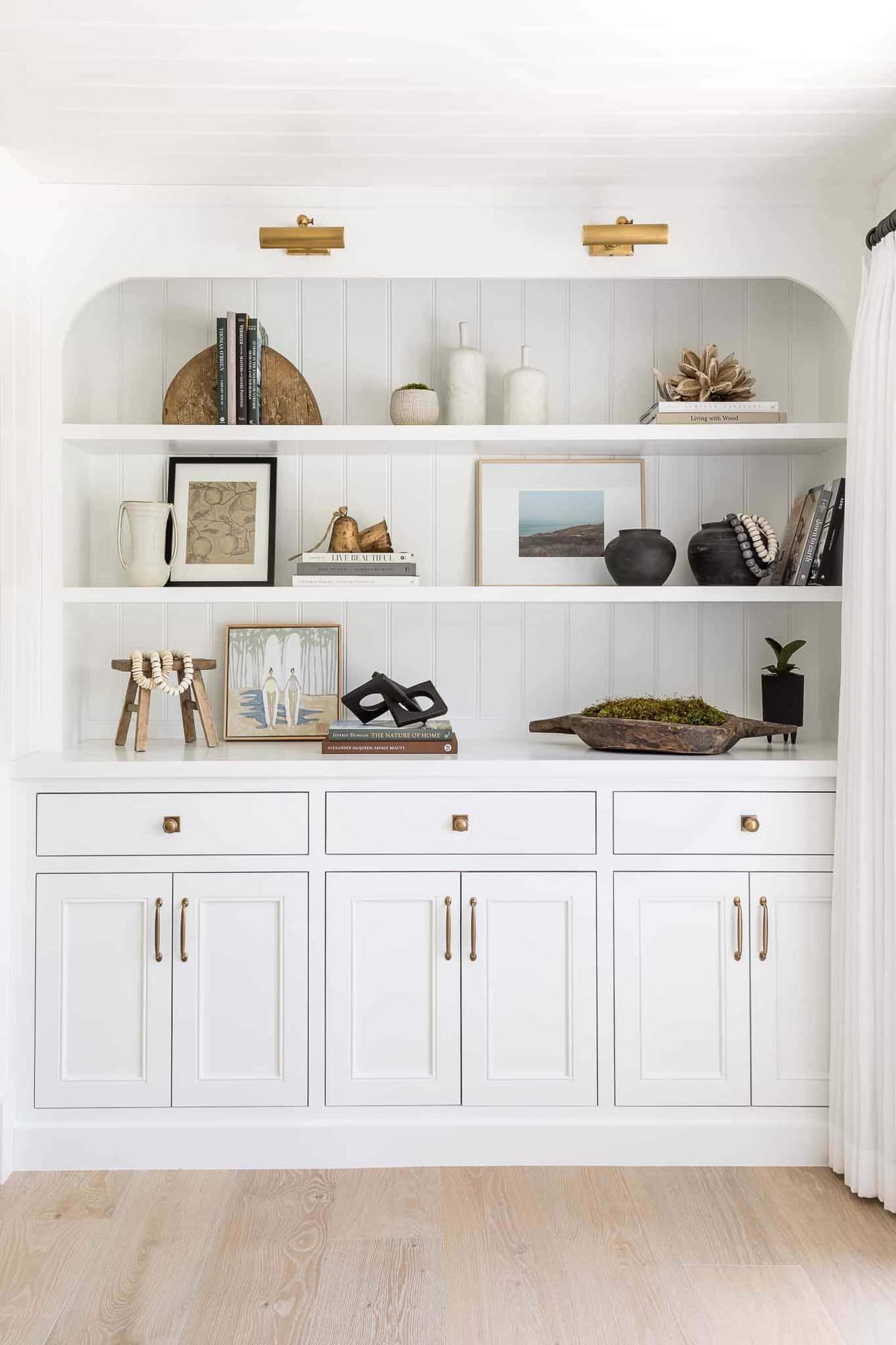 coastal farmhouse style family room with a built-in cabinet