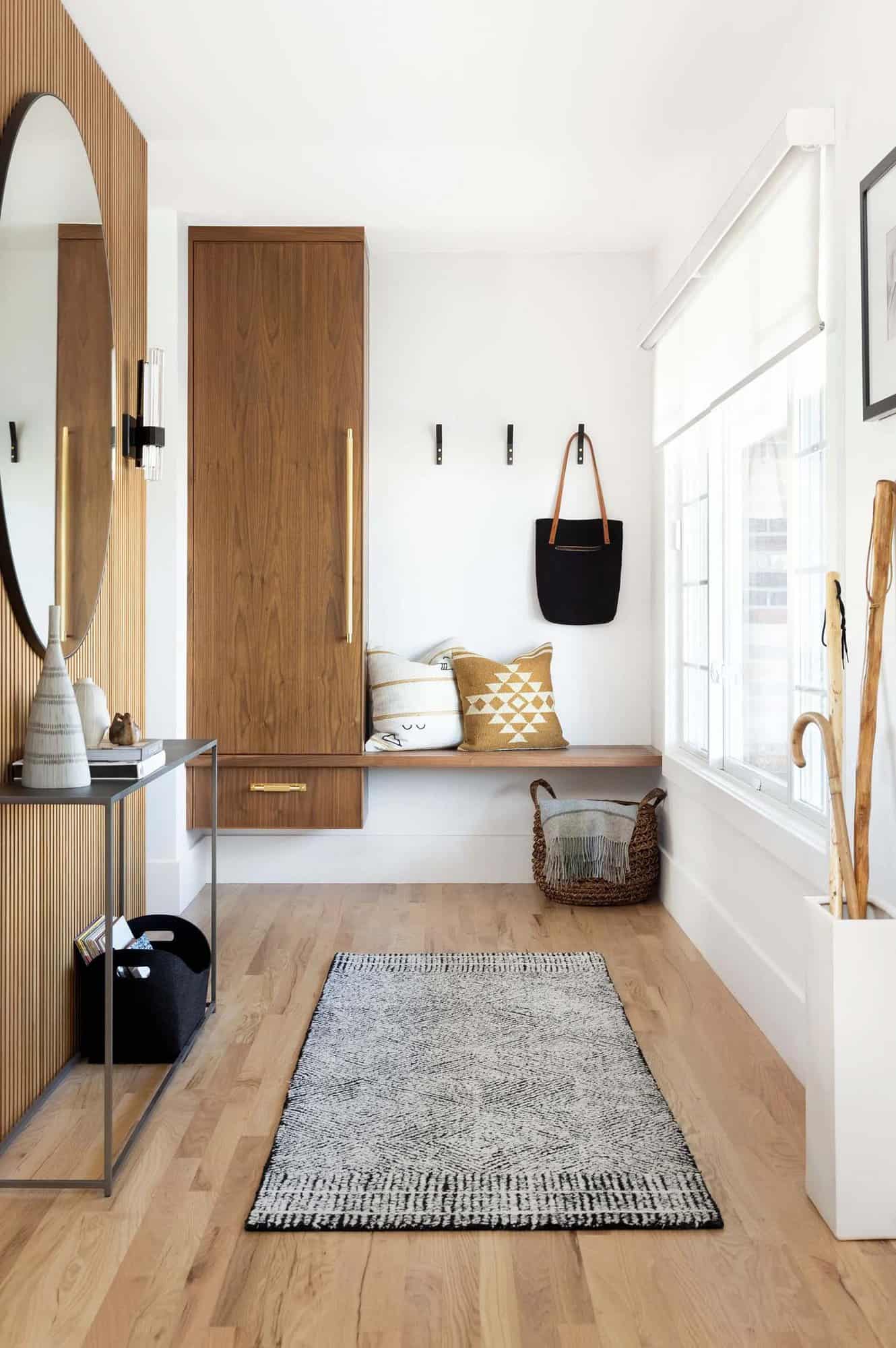 contemporary home entry with a bench and storage hooks