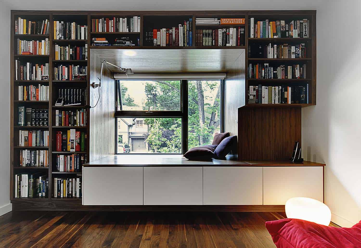 contemporary den with a window seat and built-in bookcase