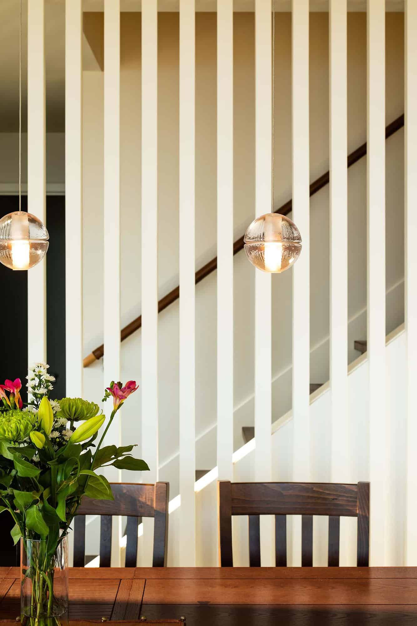 contemporary farmhouse dining room with a staircase backdrop