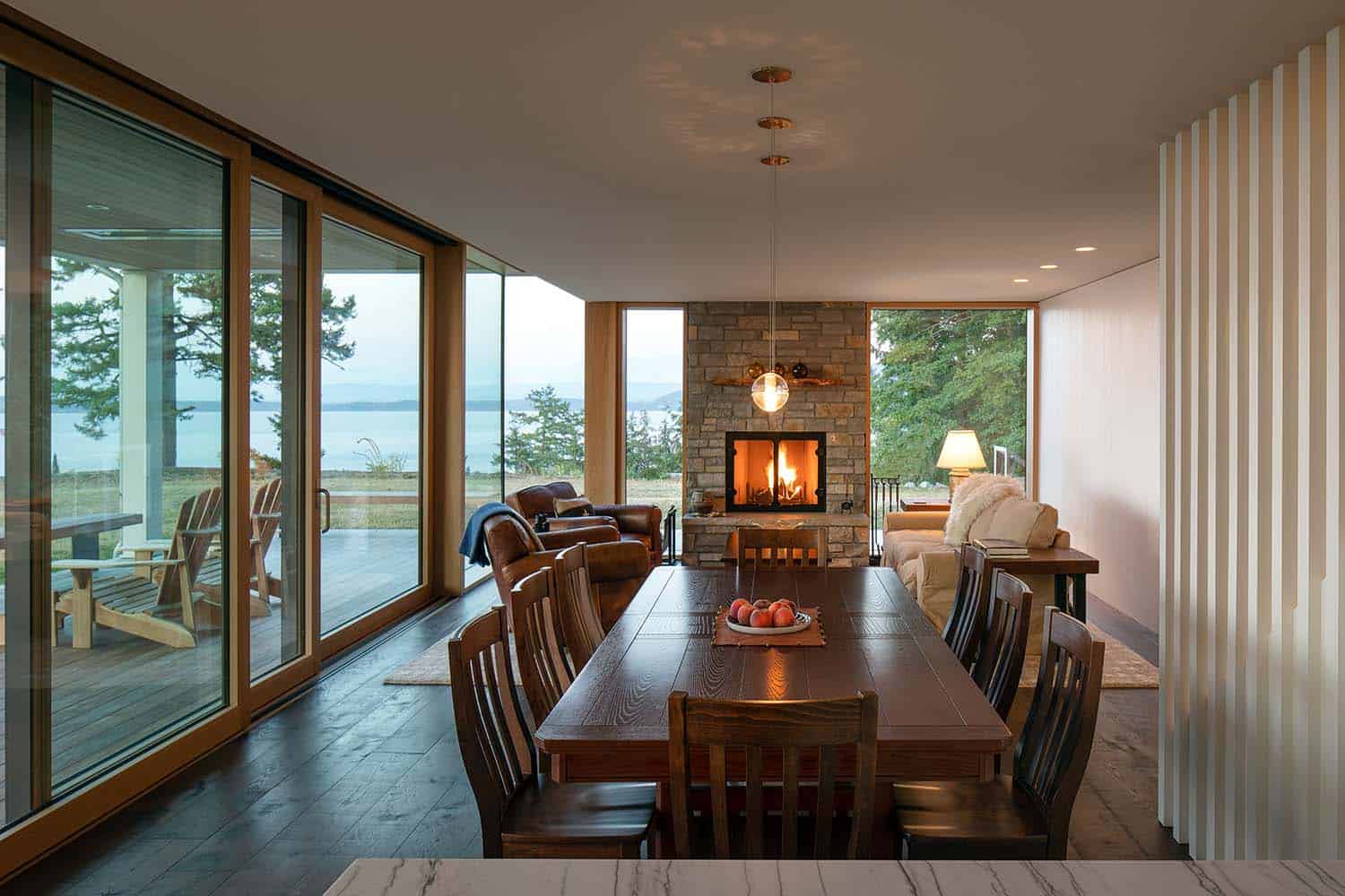 contemporary farmhouse dining room looking to the living room with a fireplace