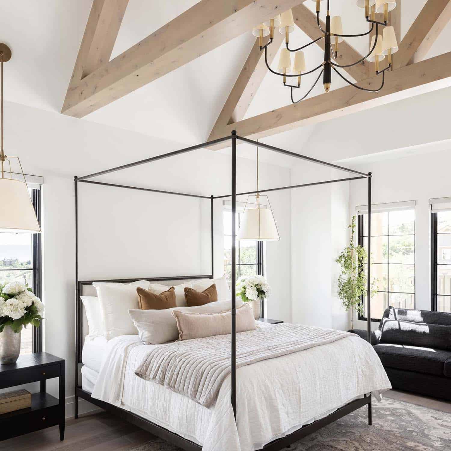 bedroom with a canopy bed, a vaulted ceiling and wood beams and wood floors