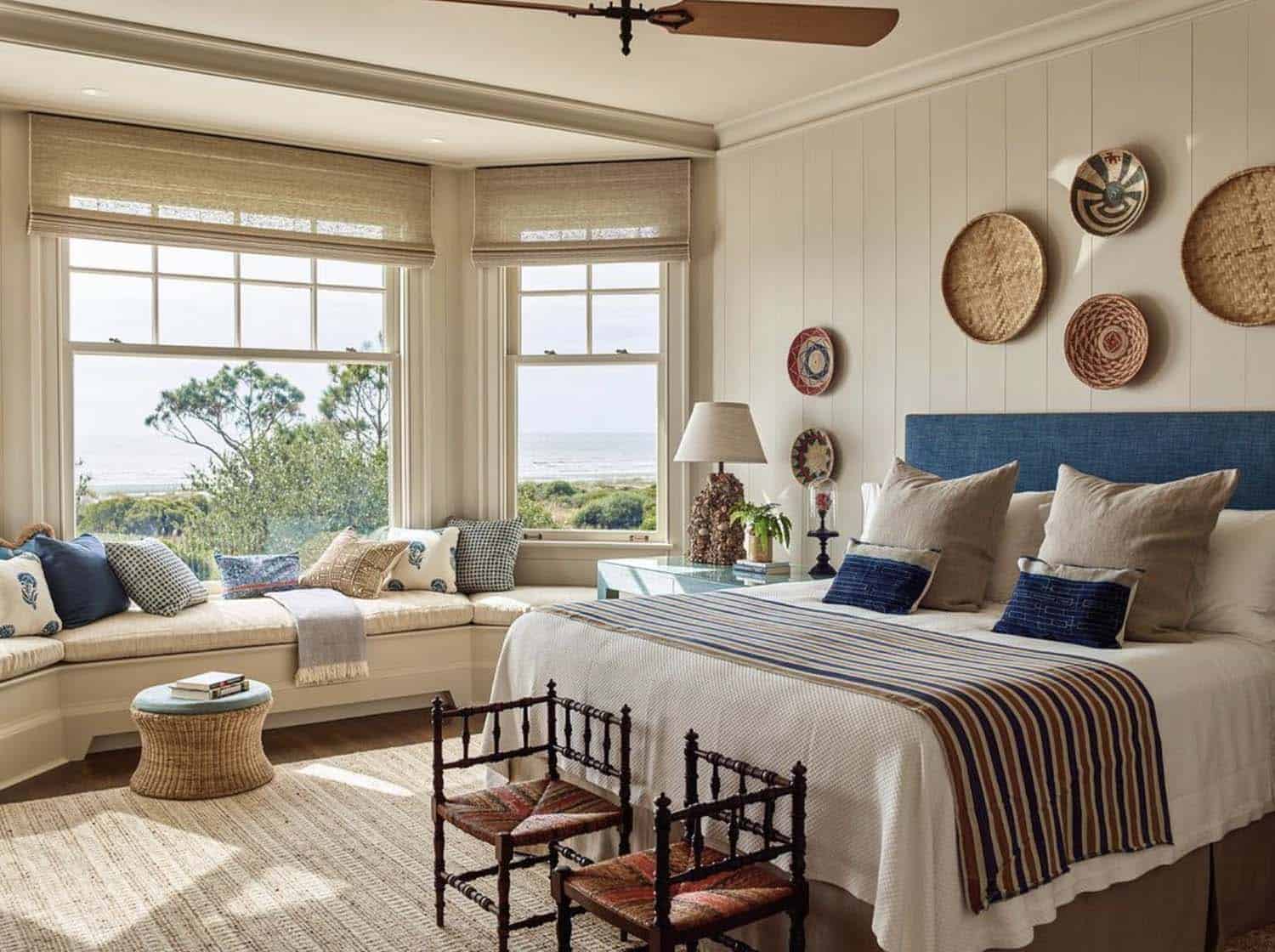 coastal-inspired guest bedroom with a bay window and an ocean view