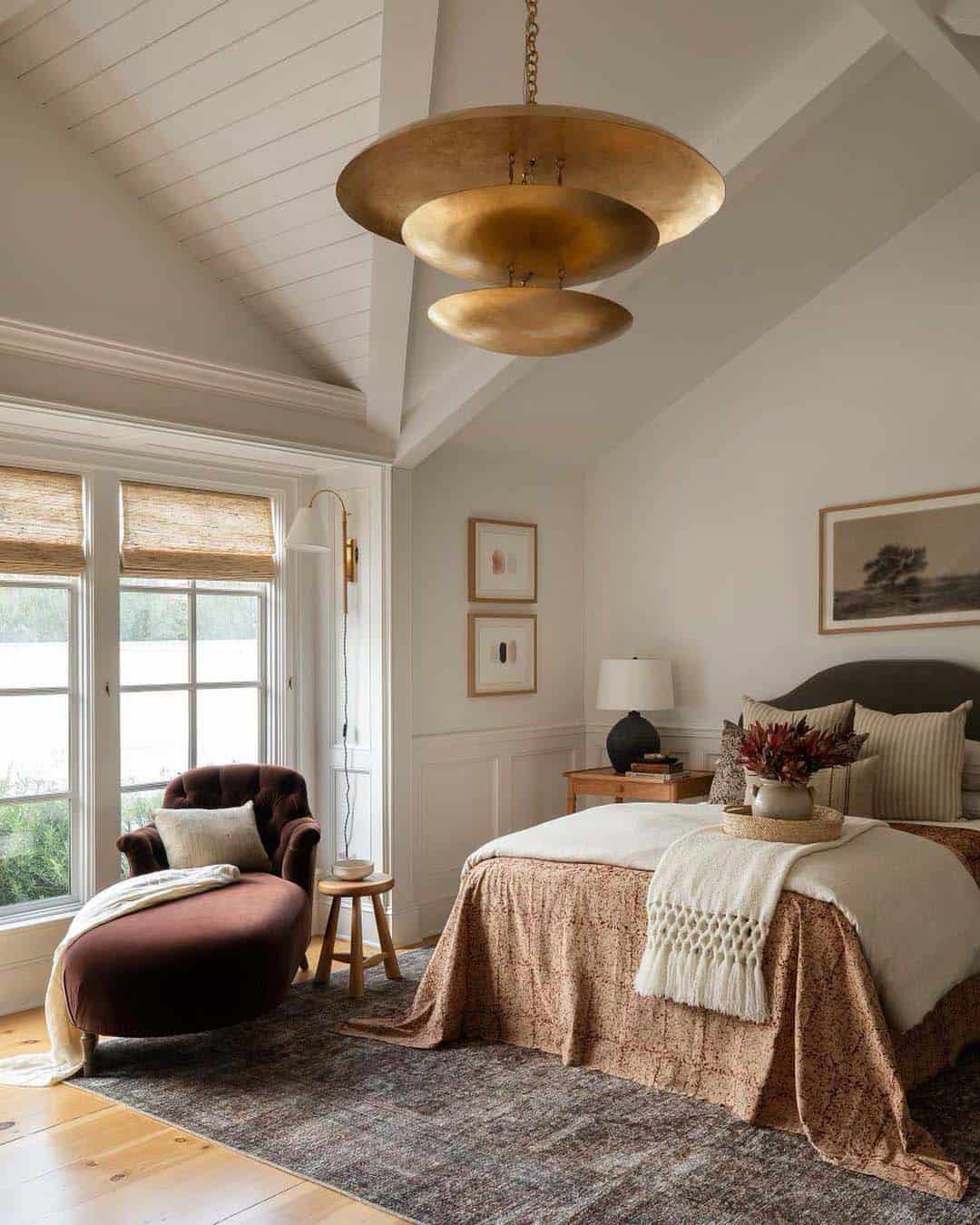 cozy bedroom with a warm color palette and a gold chandelier