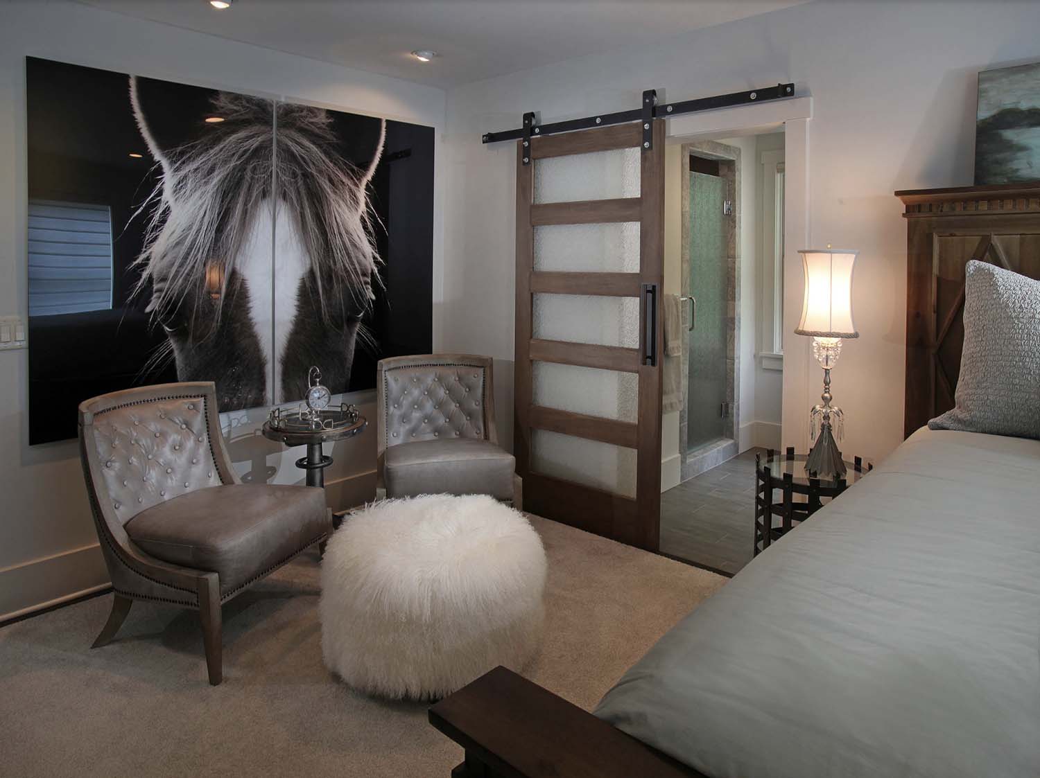 modern rustic guest bedroom with a craftsman style barn door leading into the bathroom