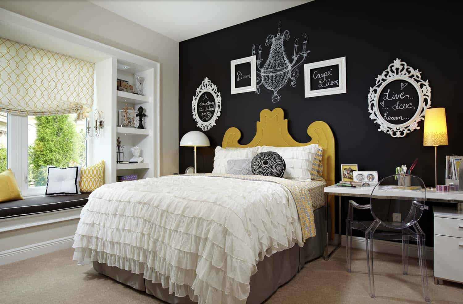 eclectic bedroom with a black chalk board accent wall and built-in window seat
