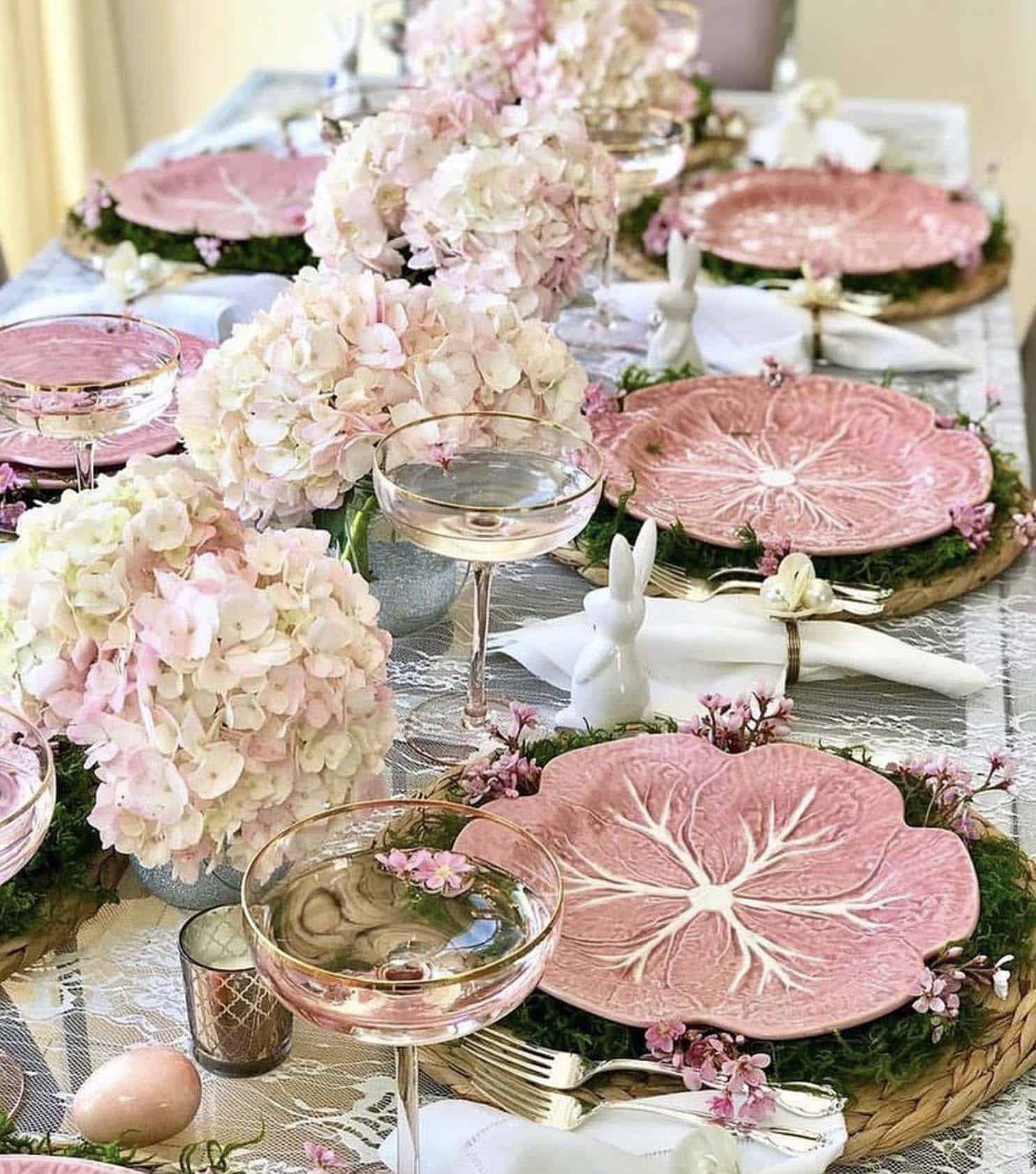 easter table setting with pink cabbage plates and pink hydrangeas in vases