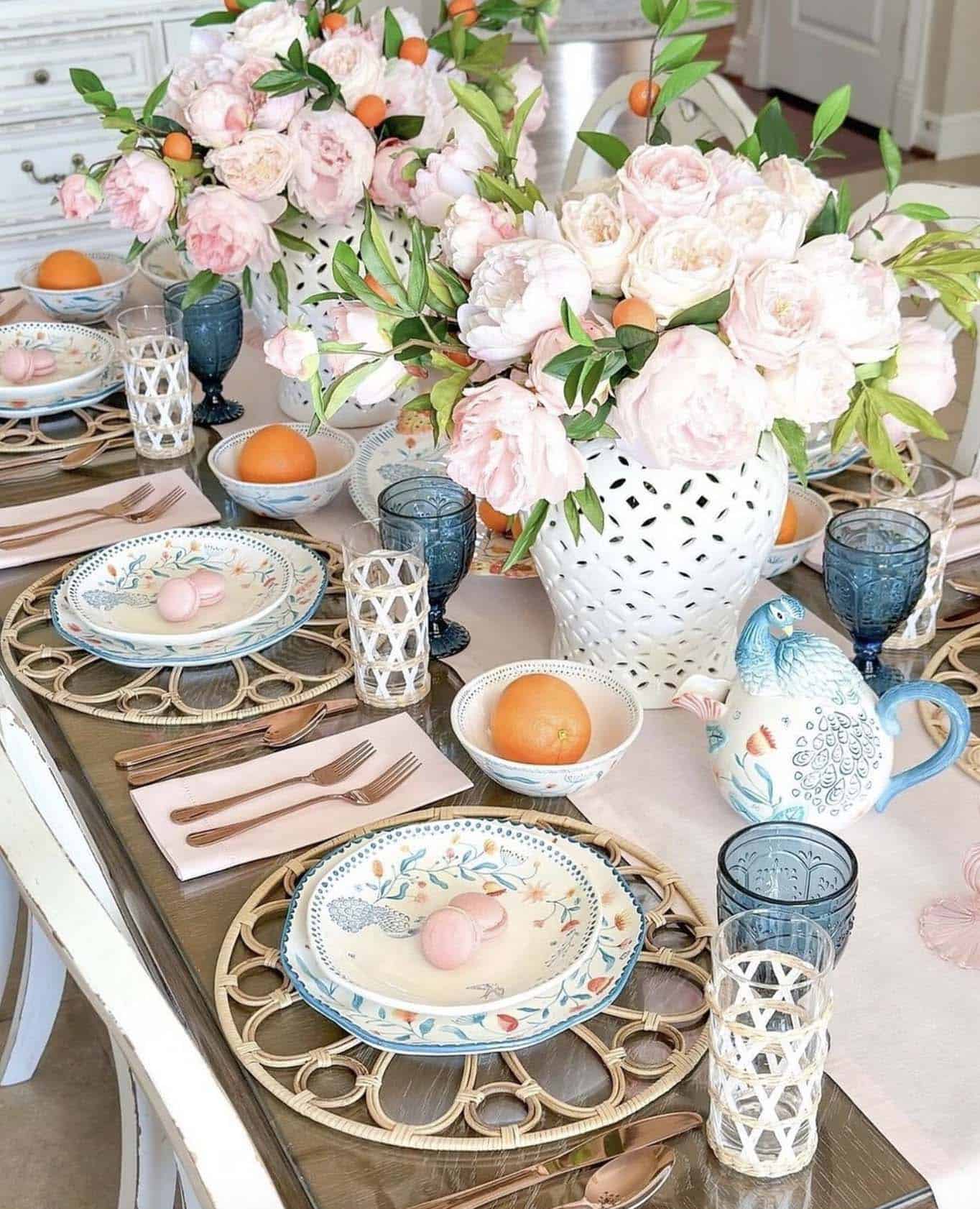 spring dining table decor with a color scheme of soft pink, blue, and a pop of orange