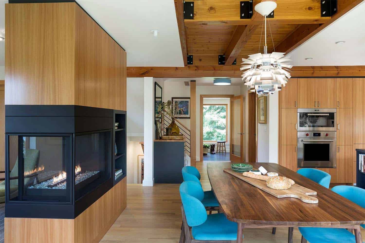 midcentury dining room with a dual-sided fireplace